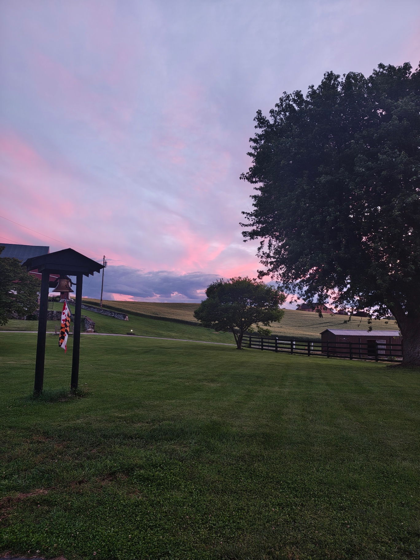Rolling Maryland countryside at dawn with a weathered barn and misty pasture